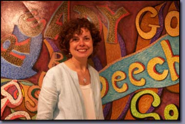 Linda Shears, Interior Designer, Author pictured in front of the Words at Play Mural painted as a volunteer with the Image and Arts Council of Troy, Michigan